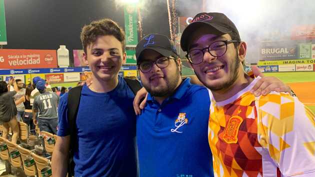 On the left, Jimenez De Luis enjoys a Dominican baseball game. JESSE MCDOUGALL/THE VARSITY